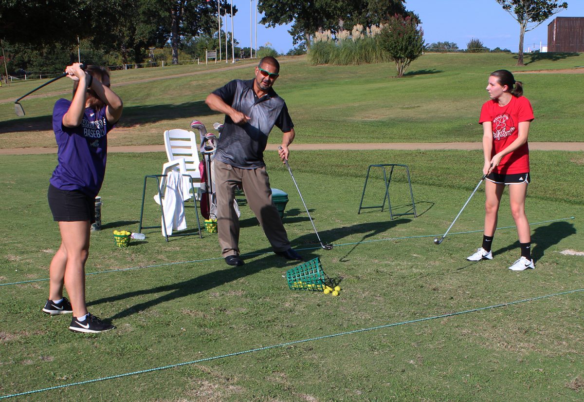 Students practice their golf skills.