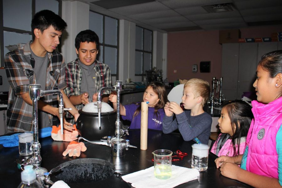 Senior Jonathan Rosales and sophomore Russel Rea engage the kids in making dry ice bubbles.