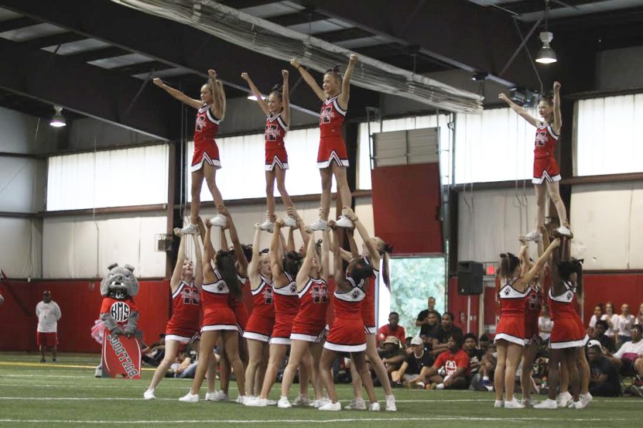 Middle school cheerleaders performs their stunt section in their performance. 