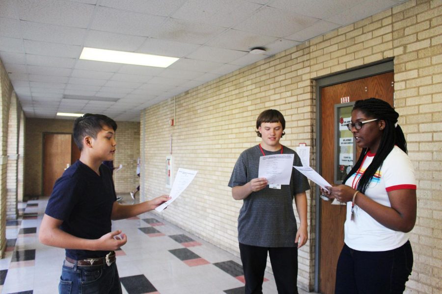 Freshman Bryan Harter, sophomore James Malick, and sophomore Brooklyn Hall practice their scene before auditions. 