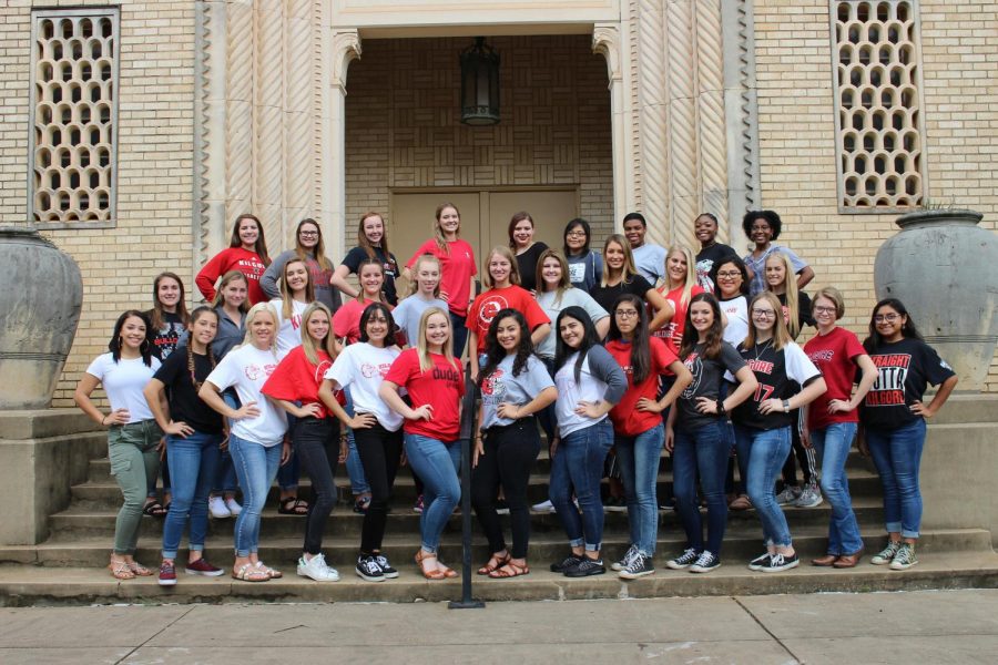 The 2018-19 homecoming duchesses gather in front of the school for a picture