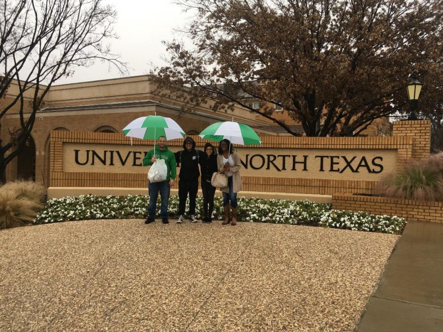 Senior Jasiaha Boaz takes picture in front of the University of North Texas school sign. 