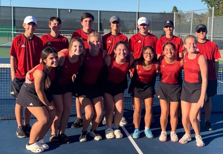 The tennis team celebrates their defeat against Crandall.