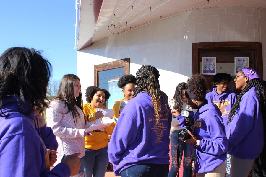 AASA members seniors Jessie  Villanueva, Kysiah Sept, Kaleigh Sammons, and junior Jaycie Villanueva interact with the community before the program.