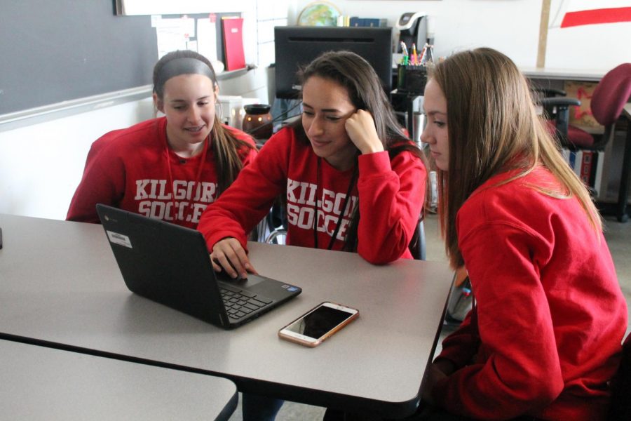 Juniors Madison Alford, Emma Taylor, and Zoe Craven work on their essay outline for their US History dual credit class.