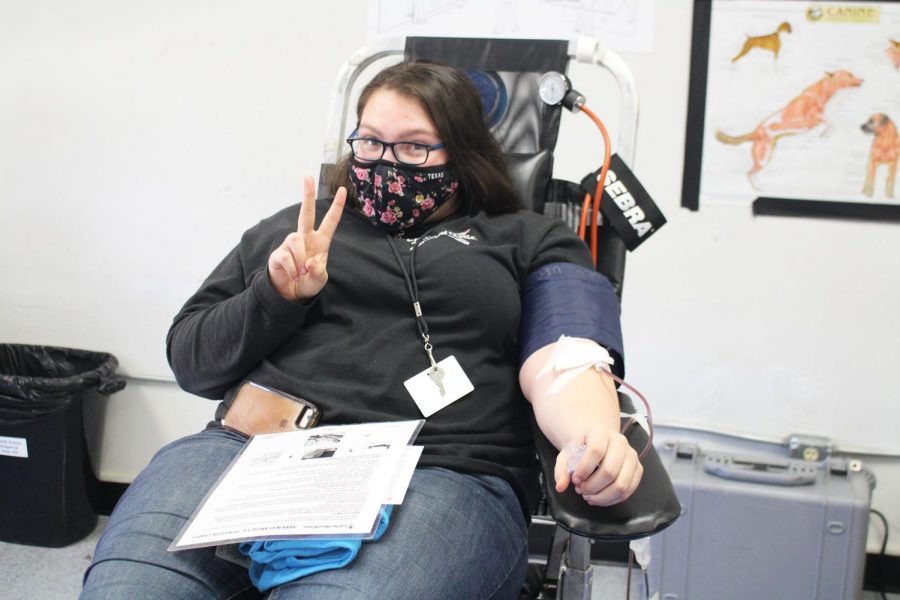 Junior Ryley Bell gives blood. She passed the screening, and is ready to save lives. 