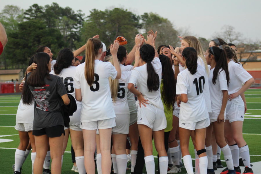Girls varsity huddle up after their 1-0 win.