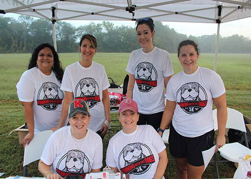 Members of the Education Foundation show their smiles before the races begin