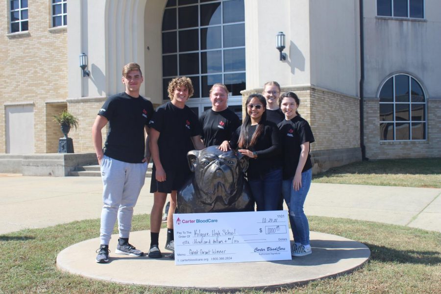 Health Science Club sponsor Cheyenne Kirkpatrick and officers Jared Rich, Cason Cox, Shanna Casayuran, Olivia Blundell, and Madison Donovan show off their winning check. 