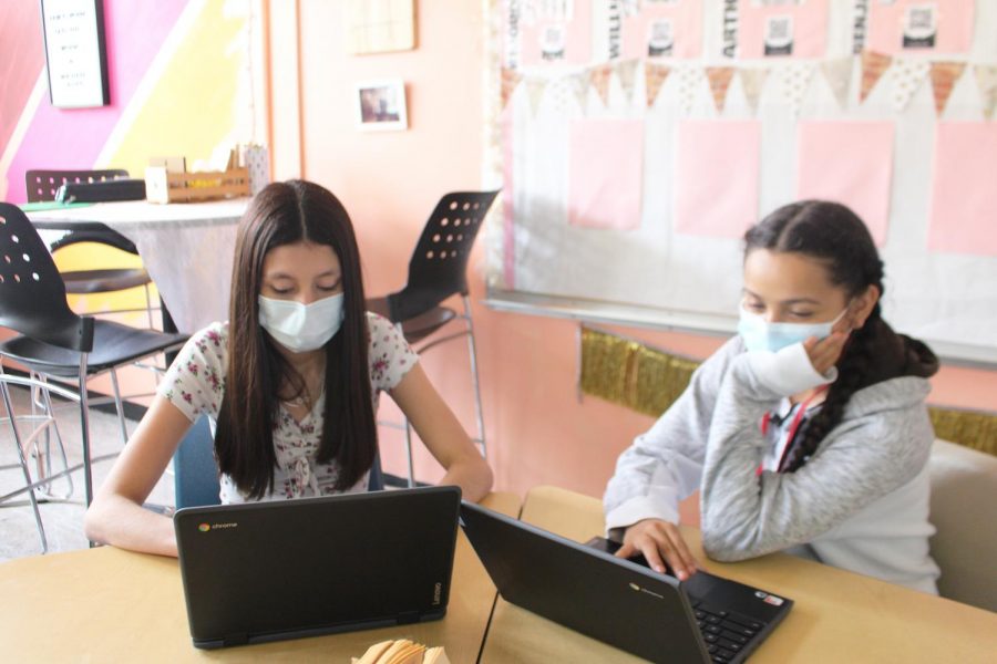Getting work done • Sophomores Marie Rodriguez and Elizabeth Gutierrez choose to wear their face masks as they work on an assignment for their English II honors class. Photo by Lizett Garcia.