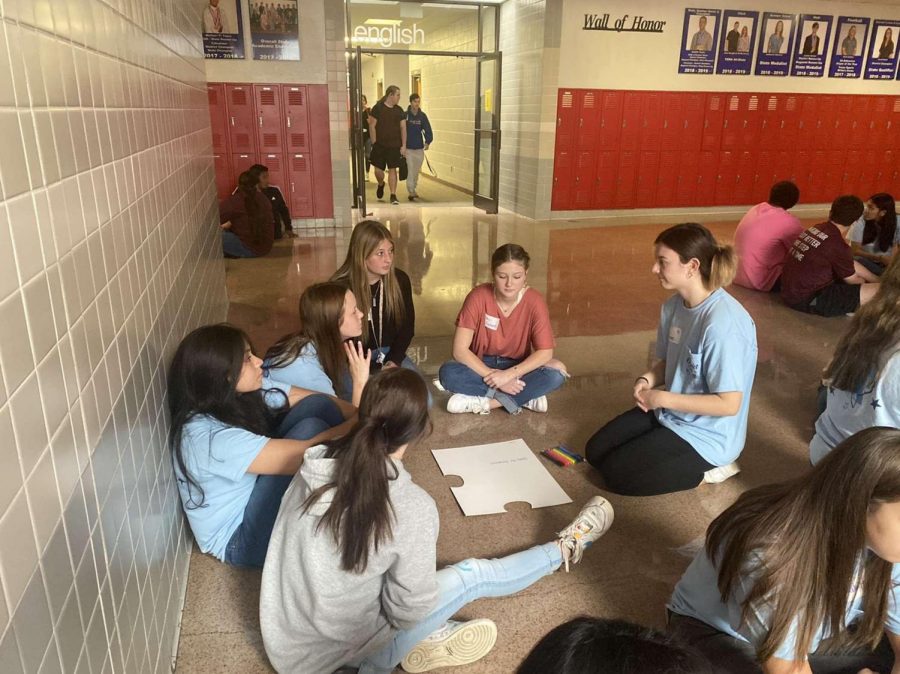 Student Council members gather around as they learn more about other students attending the conference.