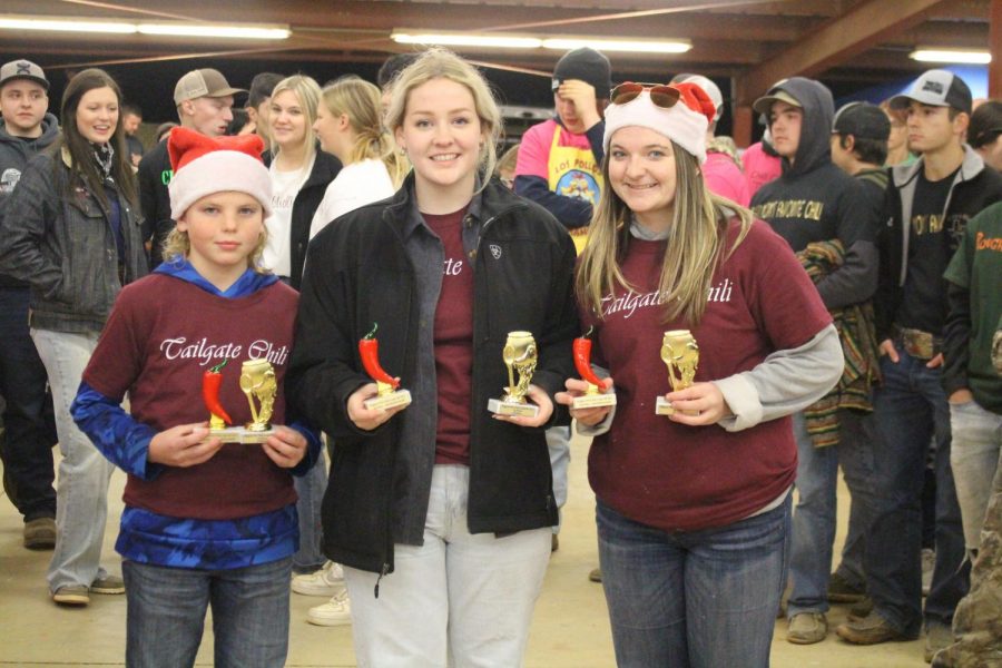 Senior Riley Rios, sophomore Hailey Posey, and 5th grader Chase Foster with their trophies. 