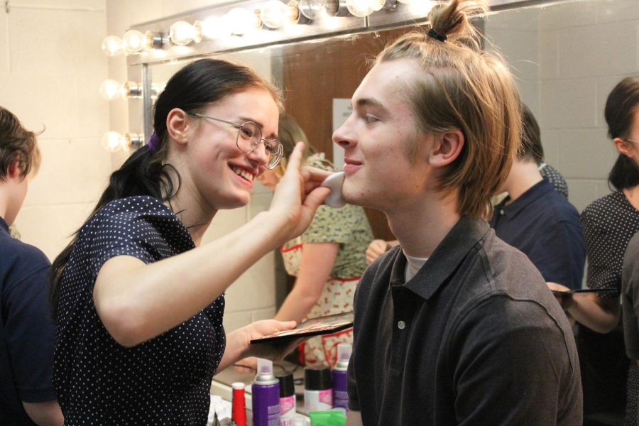 Senior Kara Malick helps senior Alan Dickson apply his stage makeup before the public performance of “All My Sons.”