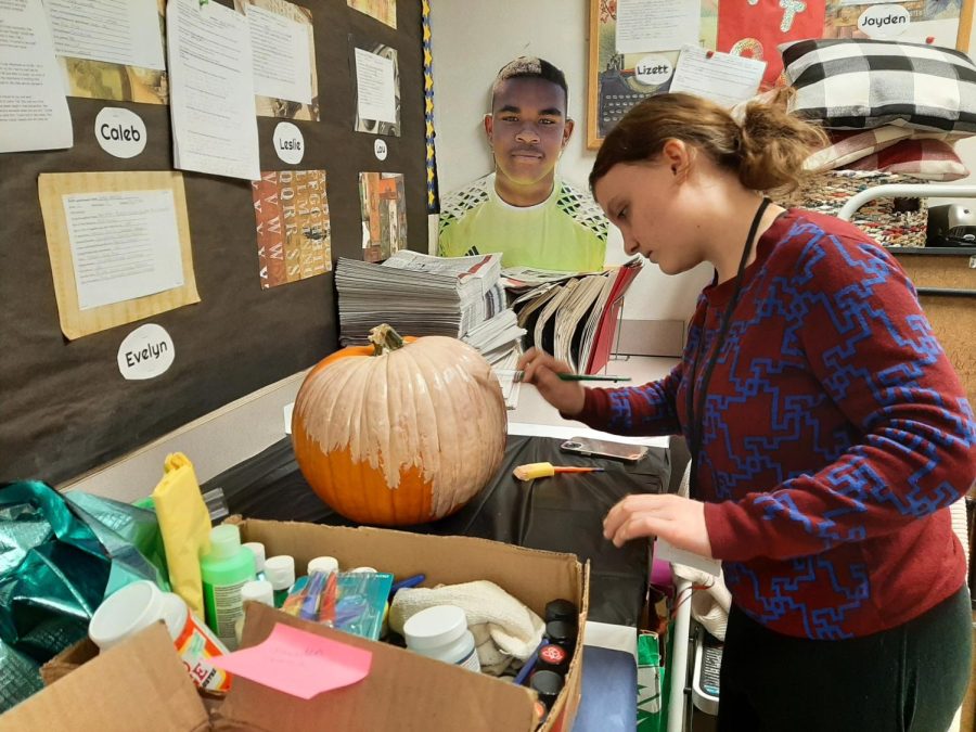 Senior Jayden Jones is hard at work while applying a coat of paint to the newspaper pumpkin.
