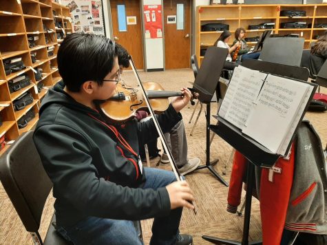 Practice makes perfect • Junior Christopher Mora practices his solo in class. Photo by Lizett Garcia.