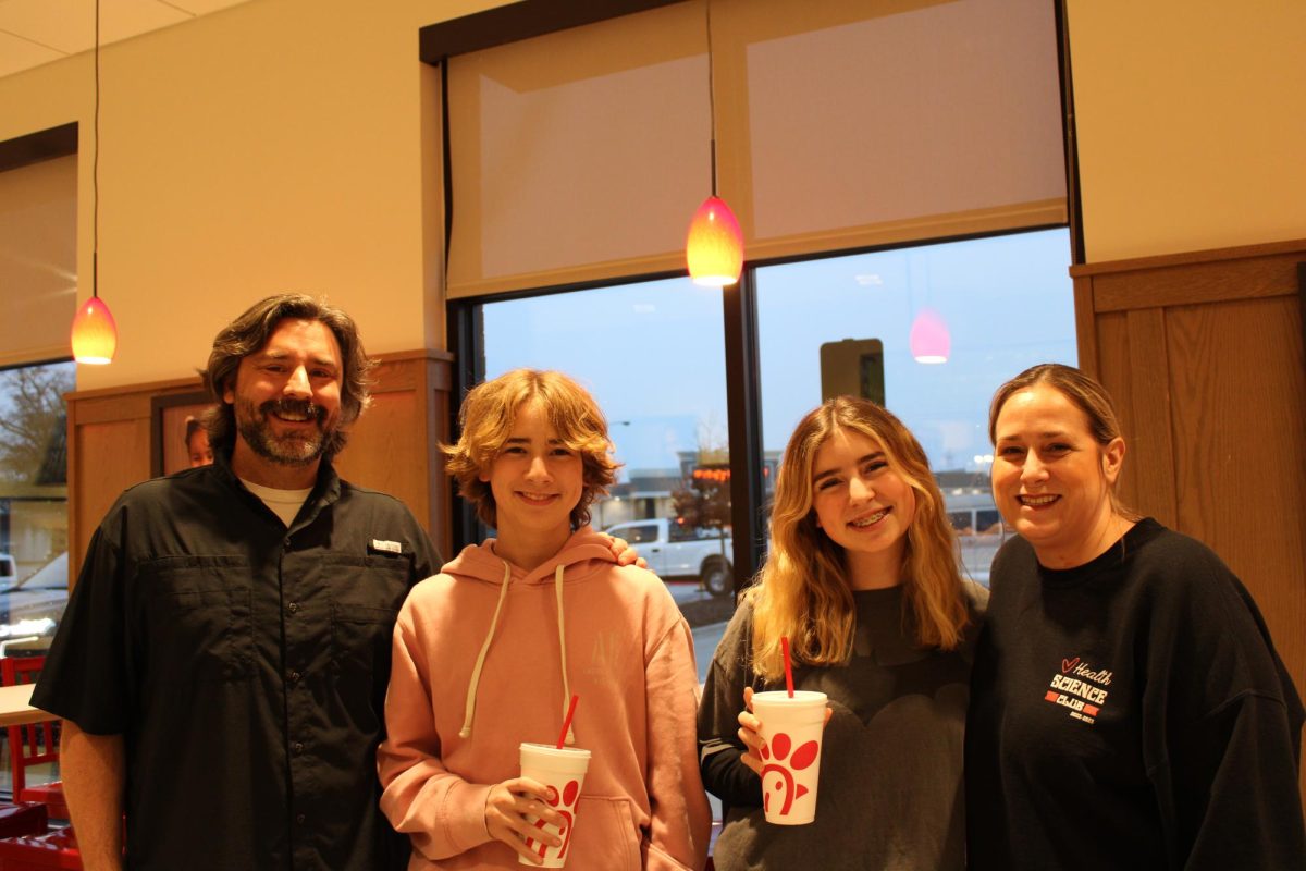 The Carlisle family poses at Chick-Fil-A during Spirit Night.