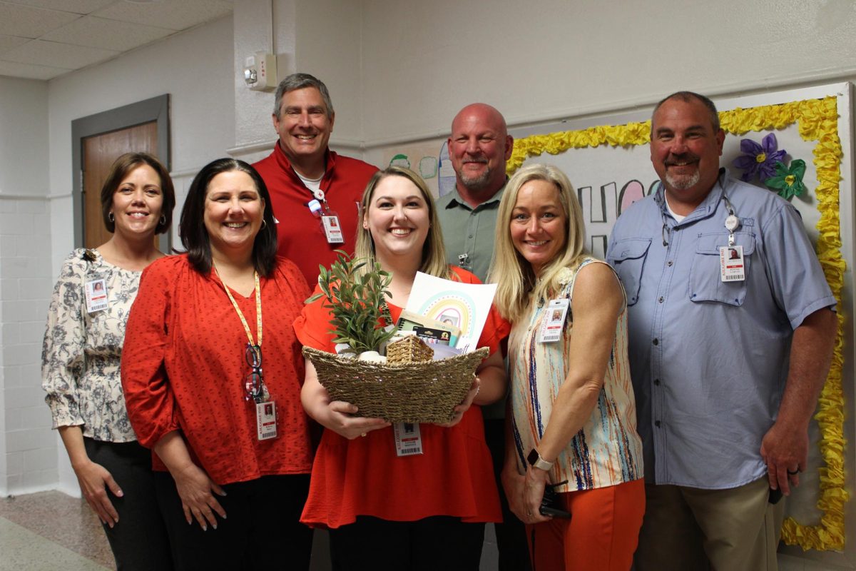 Taylor Dimmitt receives a gift basket from the admin of the school for her accomplishments in teaching