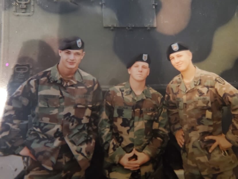 "I don't remember the name of the guy to the left of me. The guy standing on my right is Stephen Driggers," Decker (middle) said. "We did basic, AIT, and our first duty stations together."