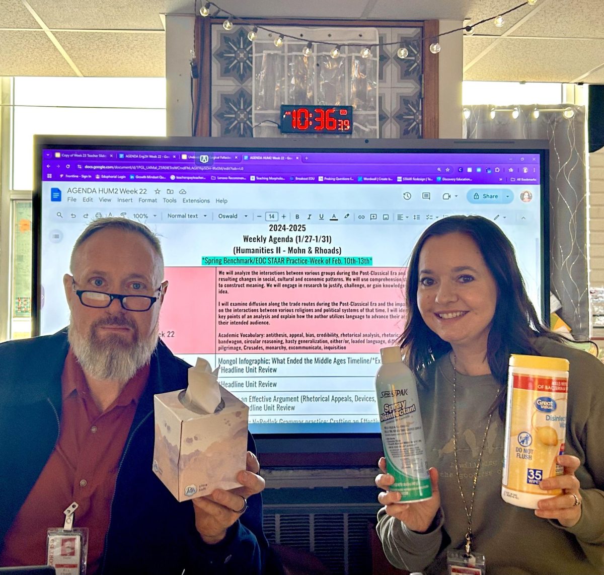 Humanities teachers Tom Rhoads and Amanda Mohn show off the different hygienic and disinfectant items they have in the classroom for students to use.