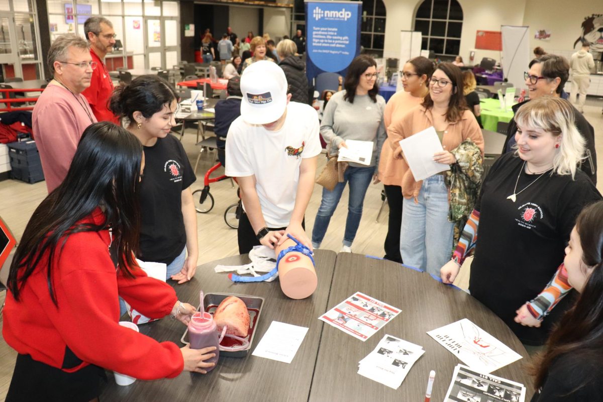 Juniors Adadlynn Martinez and Nicole Morales, and senior Daphne Crum demonstrate how to stop bleeding.