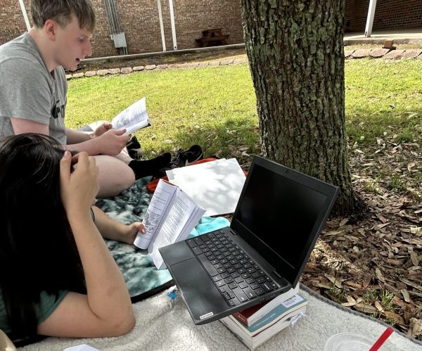 Sophomore James Jarman and Senior Syghlas Morales enjoy the outdoors as they study for Literary Criticism on the day of District.