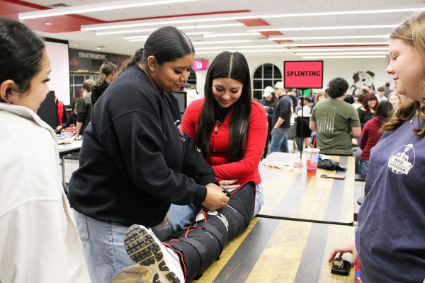 Seniors Yoselin Canchola, Jaelie Sosa, Janelle Martinez and Lydia Witherspoon demonstrate splitting at their booth.